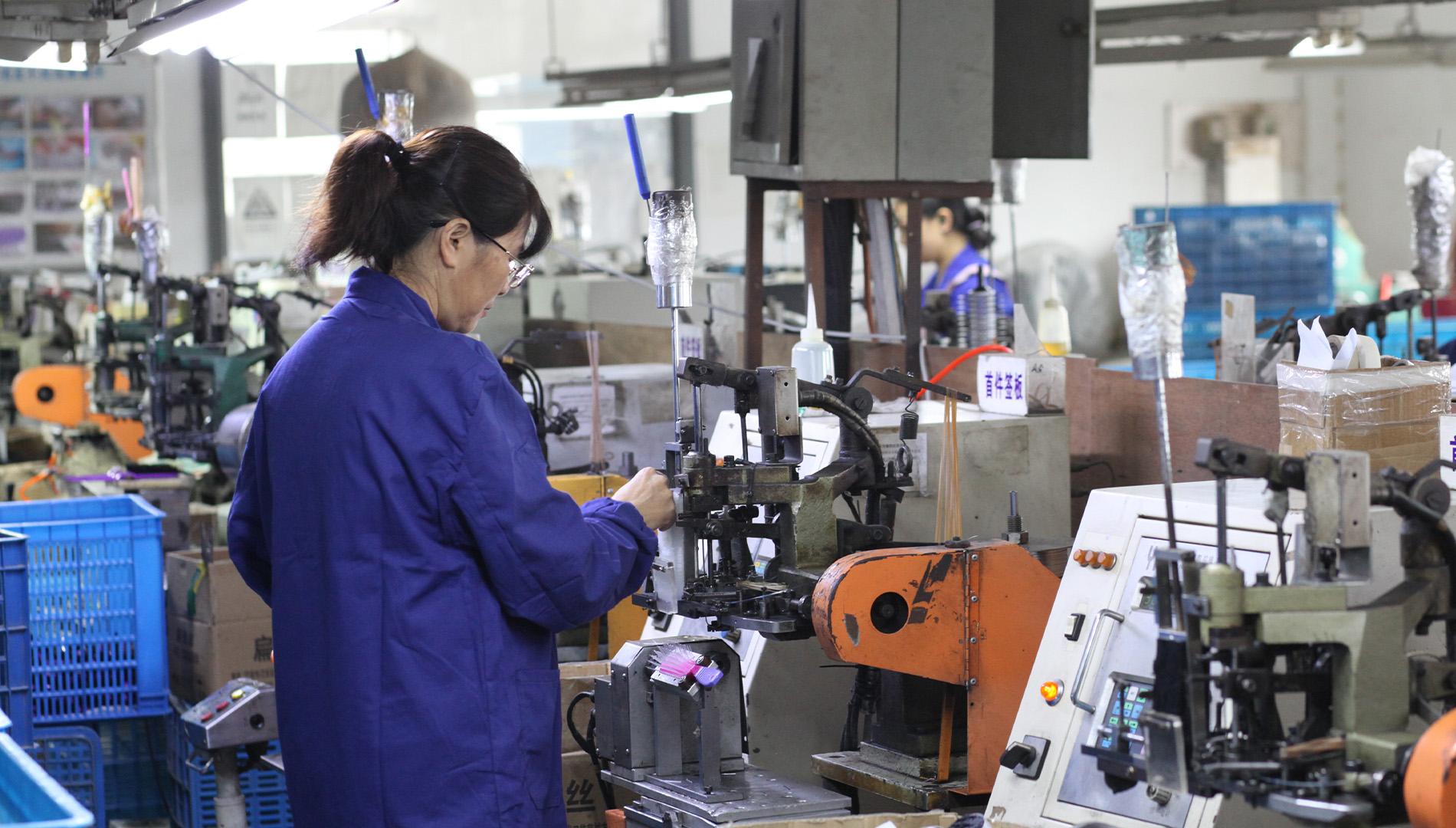 A brush tufting machine in the factory production workshop